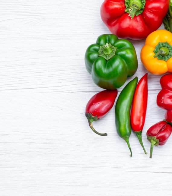top-view-green-salad-along-withful-bell-peppers-spicy-peppers-white-desk-vegetable-food-meal top-view-green-salad-along-withful-bell-peppers-spicy-peppers-white-desk-vegetable-food-meal